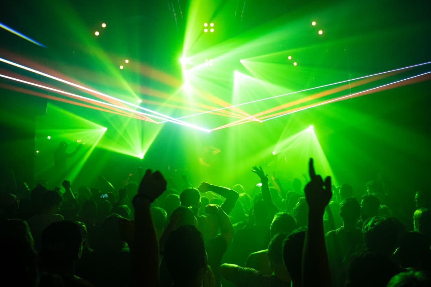 A crowded dance floor under stage lighting